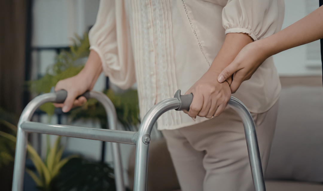 Hands supporting an adult during therapy